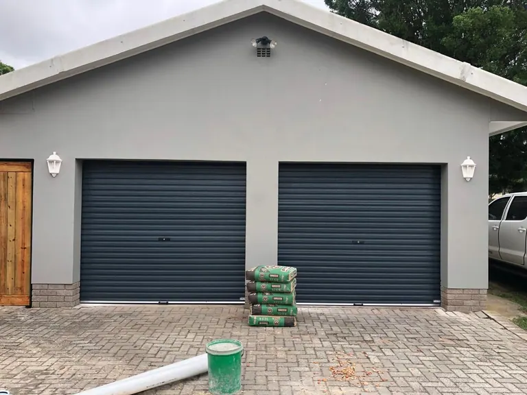 Two single charcoal roll-up garage doors