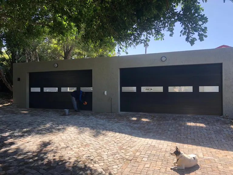 Two wide garage doors with window strips